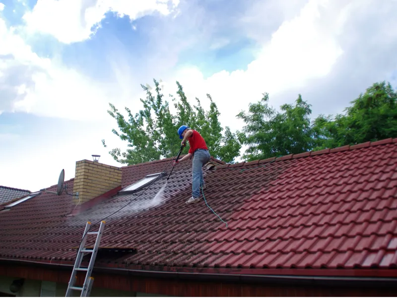 Professional high-pressure roof cleaning in progress on Perth tiled roof